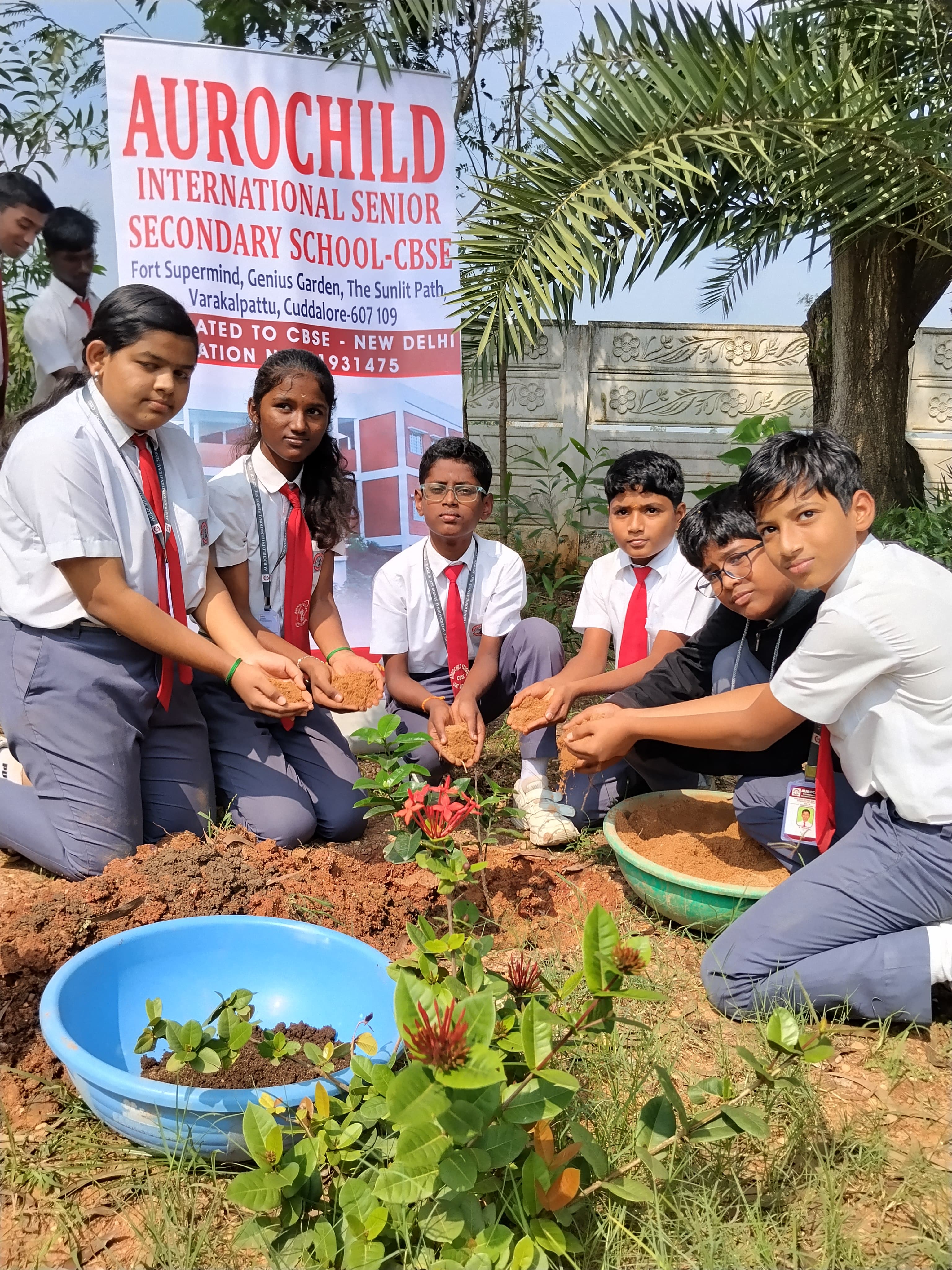 Students planting trees at Aurochild School Cuddalore