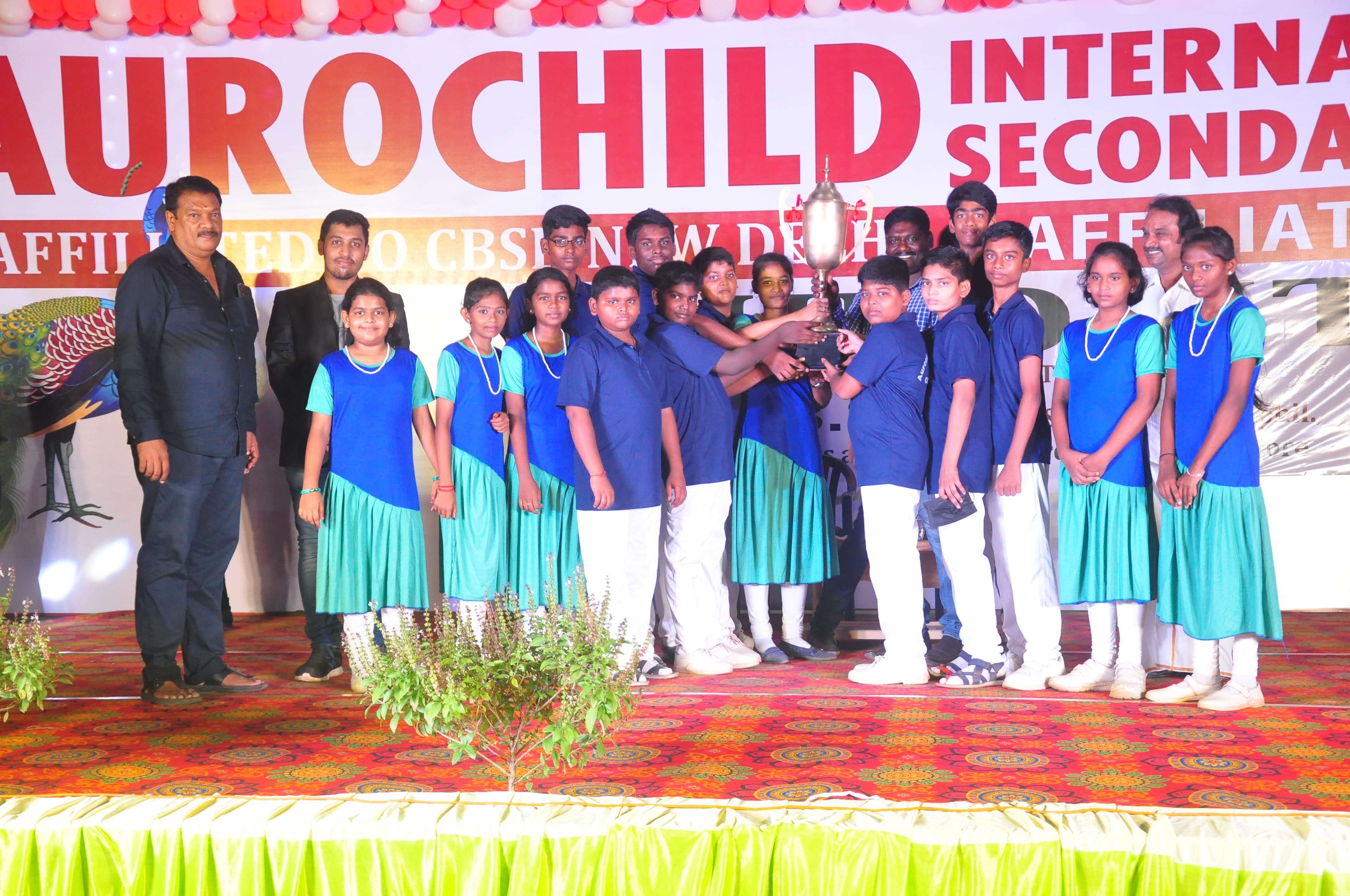 Students receiving team recognition at Aurochild