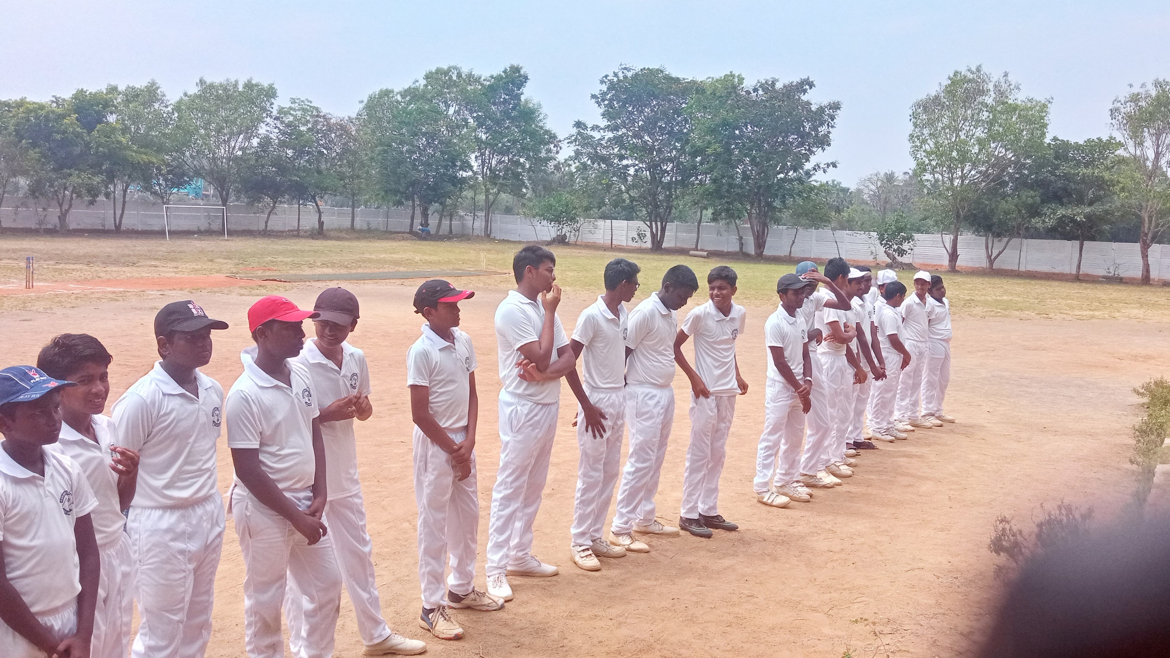Aurochild cricket teams lined up on the school grounds
